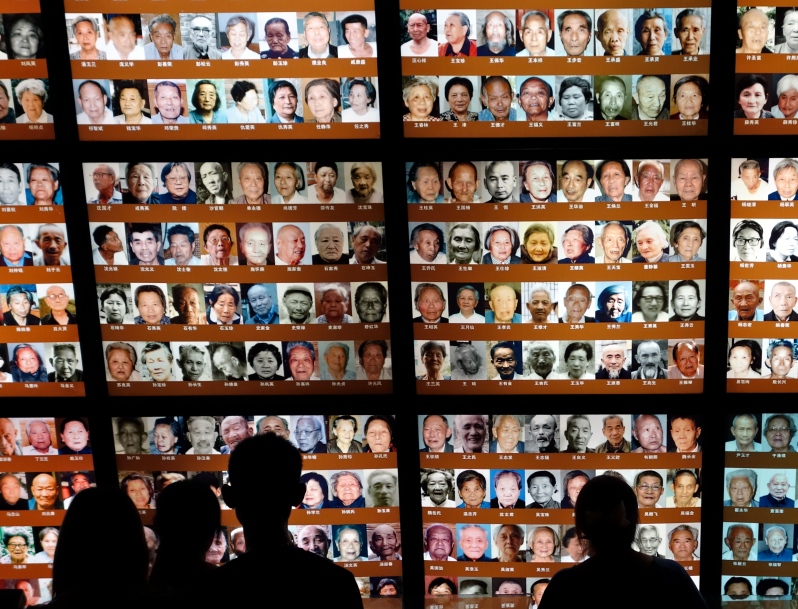 Young people view images of survivors of the Nanjing Massacre Memorial Hall in China on Dragon Boat Festival Holiday, 2013.